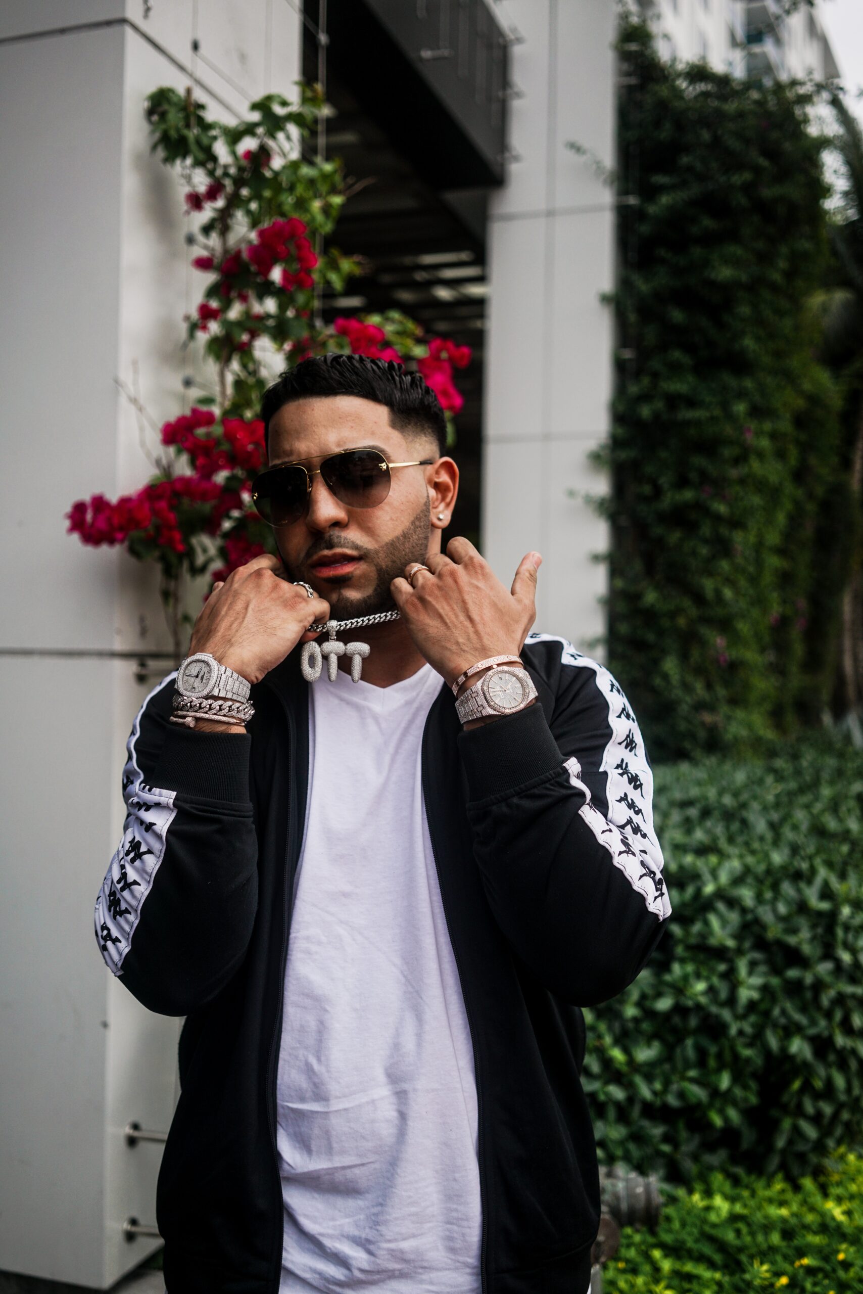 A beyorch Accredited Investor in street wear holding up an expensive chain