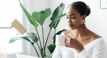 A successful black business woman managing finances on her laptop