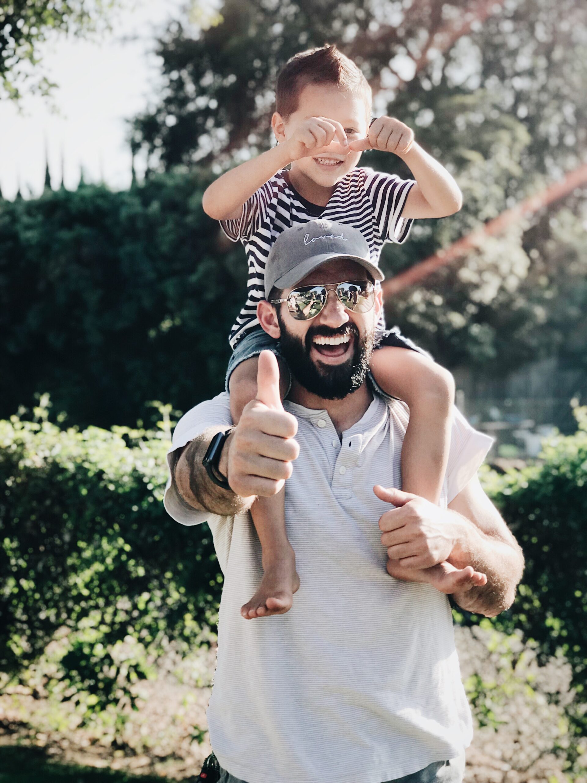 Happy investor with his son over his head that earns passive income.